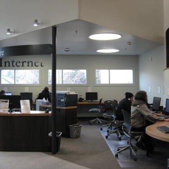 Happy Valley Library - The reference desk is placed under this overhang from the upper floor, as are the internet stations. - Libraries Near Me - Happy Valley, Oregon Happy Valley Library - The reference desk is placed under this overhang from the upper floor, as are the internet stations. - Libraries Near Me - Happy Valley, Oregon