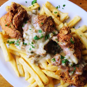 Milkweed - Buttermilk Fried Chicken with Chicken Sausage Bourbon Gravy & French Fries - New American Near Me - Boston, Massachusetts Milkweed - Buttermilk Fried Chicken with Chicken Sausage Bourbon Gravy & French Fries - New American Near Me - Boston, Massachusetts
