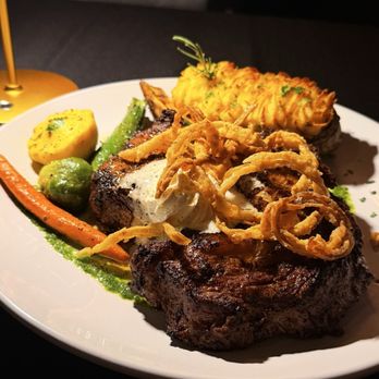 The Palms - 22 oz Bone in Rib Eye, three cheese twice baked potato, garlic herb butter, sautéed veggies. - Seafood Near Me - Fresno, California The Palms - 22 oz Bone in Rib Eye, three cheese twice baked potato, garlic herb butter, sautéed veggies. - Seafood Near Me - Fresno, California