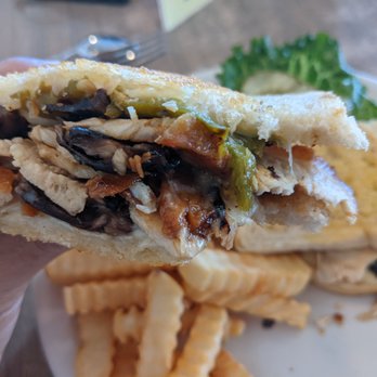 Nicely's - a hand holding a half eaten sandwich - American Near Me - Lee Vining, California