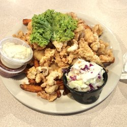 The Chowder House Restaurant - Daily special   Fried clams, grouper and shrimp. Served on a bed of fries with slaw on the side.