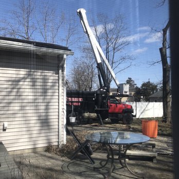 Double R Tree Service - a crane lifting a table - Tree Services Near Me Double R Tree Service - a crane lifting a table - Tree Services Near Me