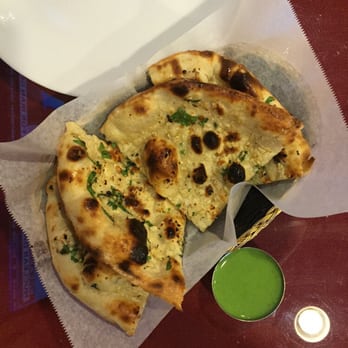 Mayuri Indian Restaurant - Garlic naan served with a bright green, spicy sauce. - Indian Near Me - Tallahassee, Florida Mayuri Indian Restaurant - Garlic naan served with a bright green, spicy sauce. - Indian Near Me - Tallahassee, Florida