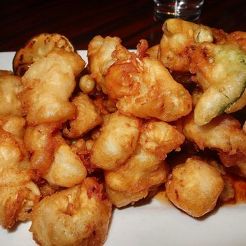 Gaetano's - The Calamari Fritti was made with breaded calamari, cherry peppers, and house-made marinara sauce. The calamari was coated in a puffy batter - Italian Near Me - Denver, Colorado Gaetano's - The Calamari Fritti was made with breaded calamari, cherry peppers, and house-made marinara sauce. The calamari was coated in a puffy batter - Italian Near Me - Denver, Colorado