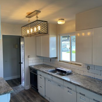 Cretewood  Construction -  kitchen with white cabinets and granite countertops - General Contractors Near Me
