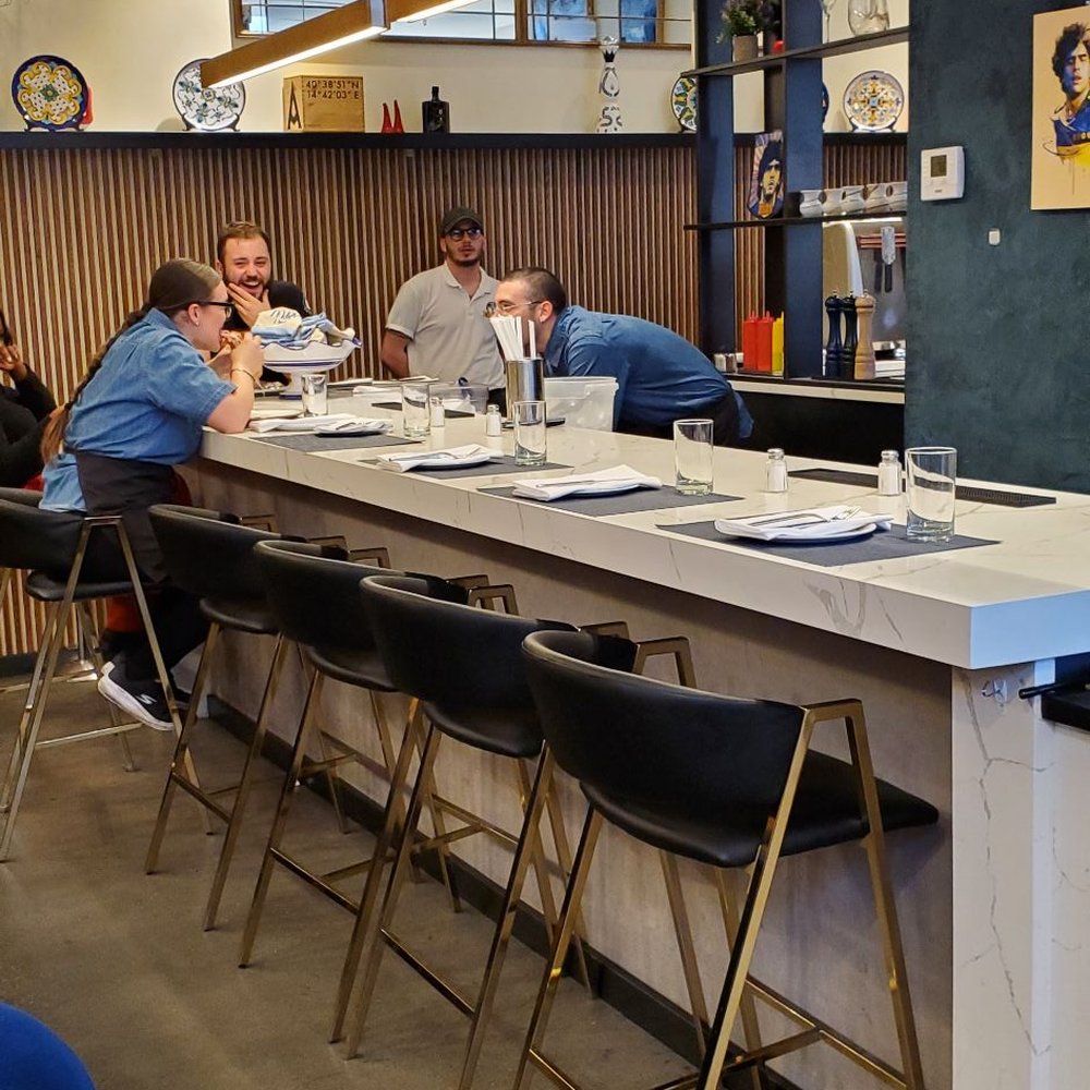 Song E Napule - Rutherford - a group of people sitting at a bar - Pizza Near Me - Rutherford, New Jersey