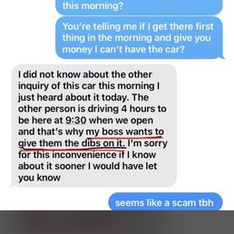 The image shows a screenshot of a text message conversation. One person discusses a car inquiry, mentioning that the other person is driving for four hours to meet at 9:30 AM and refers to giving a 'dibs on it.' The other person responds skeptically, suggesting it seems like a scam. The conversation involves concerns about a potential scam related to a car purchase or inquiry.