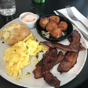 Magnolia Table - Perfectly scrambled eggs, light and flaky biscuits, homemade tater tots and delicious, crisp bacon. - Breakfast & Brunch Near Me - Waco, Texas Magnolia Table - Perfectly scrambled eggs, light and flaky biscuits, homemade tater tots and delicious, crisp bacon. - Breakfast & Brunch Near Me - Waco, Texas