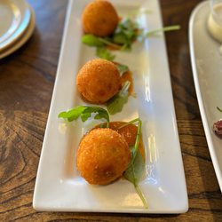 FolkArt - GRIT FRITTERS - House made grits with cheddar cheese and jalapeños, deep fried and served with house made peach-habanero jam.