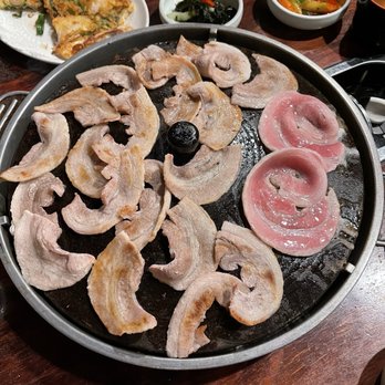 Yechon - Pork belly cooking  on the grill. - Korean Near Me - Annandale, Virginia