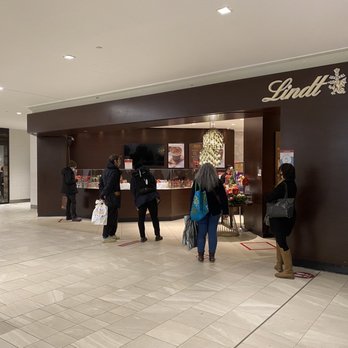 Lindt - a group of people in a mall - Chocolatiers & Shops Near Me - Montreal, Quebec