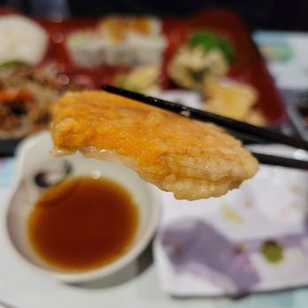 Tenon Vegetarian Cuisine - a person holding a piece of food with chopsticks - Sushi Bars Near Me - Markham, Ontario Tenon Vegetarian Cuisine - a person holding a piece of food with chopsticks - Sushi Bars Near Me - Markham, Ontario