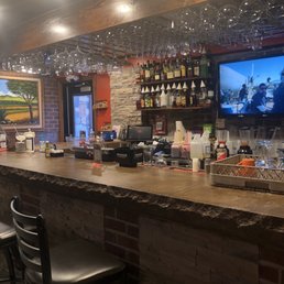 a bar with a television and bar stools a bar with a television and bar stools