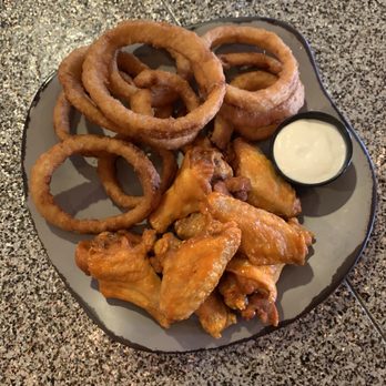 Bobtown Brewhouse & Grill - a plate of fried wings and onion rings - Bars Near Me - Roberts, Wisconsin Bobtown Brewhouse & Grill - a plate of fried wings and onion rings - Bars Near Me - Roberts, Wisconsin