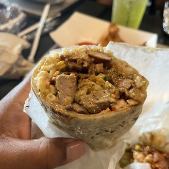 Roll On In - a hand holding a burrito - Asian Fusion Near Me - Sevierville, Tennessee Roll On In - a hand holding a burrito - Asian Fusion Near Me - Sevierville, Tennessee