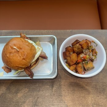 Nic & Luc - Bacon Egg & Cheese Sandwich with Potatoes - New American Near Me - Orlando, Florida Nic & Luc - Bacon Egg & Cheese Sandwich with Potatoes - New American Near Me - Orlando, Florida