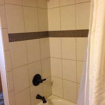 Two Ells Home Improvements - Tiles, tub, oil-rubbed bronze fixtures. - General Contractors Near Me