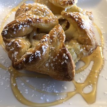 Bauhaus - Brie Bombs: Crisp Flakey Strudel with Brie Cheese, Roasted Garlic, topped with powder sugar and local organic honey - Wine Bars Near Me - Modesto, California Bauhaus - Brie Bombs: Crisp Flakey Strudel with Brie Cheese, Roasted Garlic, topped with powder sugar and local organic honey - Wine Bars Near Me - Modesto, California