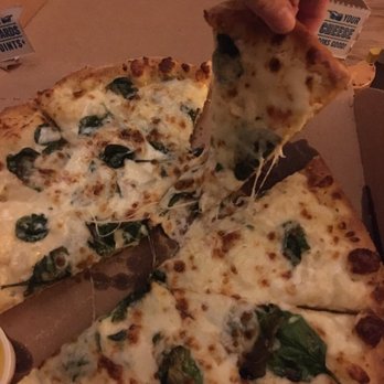 Domino's Pizza - a person taking a slice of pizza - Pizza Near Me - Lewisville, Texas Domino's Pizza - a person taking a slice of pizza - Pizza Near Me - Lewisville, Texas