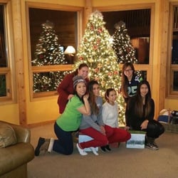 Red Roof Lodge - The girls posting in front of the decorated Christmas tree that the owner did for us.