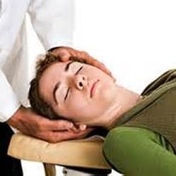 Family Chiropractic Center - This young woman relaxes as she receives a gentle manipulation to her upper neck.  (Say goodbye to that headache.)