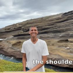 Massage Gun Therapy - man smiling by the cliffside and a caption of "the shoulder" is written in white at the bottom right
