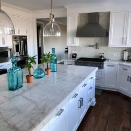 Kitchen and island w/ quartzite countertop and under the counter lighting