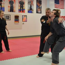 Amerikick West Linn - Grand master Dennis Tosten karate chopping sensei Brendan, owner of Amerikick West Linn