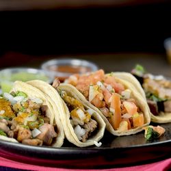 Fiesta Taco - A cherished family heirloom at Fiesta Taco, our Buche Asada Chicken Taco layers silky buche, perfectly seared asada, and succulent chicken o