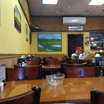 Sunnyside Cafe - Art on the wall appears to be from local artists. Colorful decor. - Cafes Near Me - Melbourne Beach, Florida