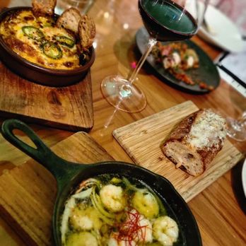 Rigo - Tapas paired with a glass of tempernillo and a side of garlic parmesan cheese to dip and soak up all the flavors! - Spanish Near Me - Honolulu, Hawaii Rigo - Tapas paired with a glass of tempernillo and a side of garlic parmesan cheese to dip and soak up all the flavors! - Spanish Near Me - Honolulu, Hawaii