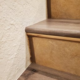 Grout messy and undone between wall and riser