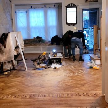 Juncal's Flooring - two men working on the floor - Carpet Installation Near Me Juncal's Flooring - two men working on the floor - Carpet Installation Near Me