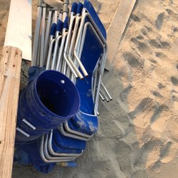 OBX Beach Cabana Services - Rented items stacked at bottom of beach access stairs
