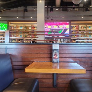 BJ's Restaurant & Brewhouse - A far away view of the main screen over the bar... - Breweries Near Me - Huntington Beach, California