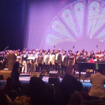 Cramton Auditorium - a choir performing in front of a large screen - Music Venues Near Me - Washington, DC, District of Columbia