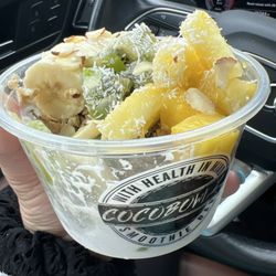 Coco Bowlz - Coconut base, granola, banana, kiwi and pineapple with almond shavings and coconut flakes topped with a honey drizzle.