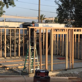 Top Quality Framing - a man standing on a ladder - General Contractors Near Me Top Quality Framing - a man standing on a ladder - General Contractors Near Me