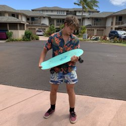 Makai Skate Shop - Cradling his brand new Carver board