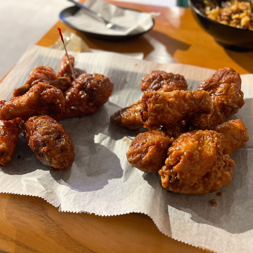 Bonchon Flushing Northern - a plate of fried food on a table - Korean Near Me - Flushing, New York Bonchon Flushing Northern - a plate of fried food on a table - Korean Near Me - Flushing, New York