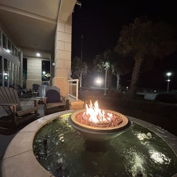 Oceanaire Resort - 1st floor fire pit with plenty of comfortable rocking Adirondack chairs. - Hotels Near Me - Virginia Beach, Virginia