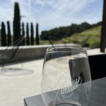 L'Aventure Winery - a glass of wine on a table - Wineries Near Me - Paso Robles, California L'Aventure Winery - a glass of wine on a table - Wineries Near Me - Paso Robles, California