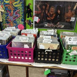 Antique Mall of Stillwater - A table with a decent selection of vinyl records and band memorabilia.