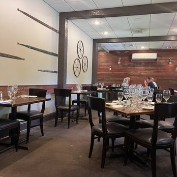 IL Granaio - a dining room with tables and chairs - Italian Near Me - Glen Mills, Pennsylvania
