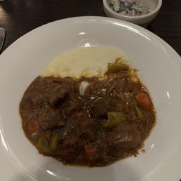 Goulash with mashed potatoes and cucumber salad.