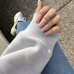 Fresh set of neutral colored acrylic nails, medium almond by Tommy