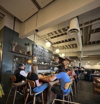 Photo of Hearth Artisan Pizza - Anchorage, AK, US. a group of people sitting at a table