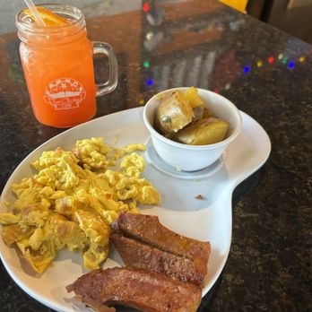Two Chicks Cafe - 2 choice breakfast plate at two chicks Cafe Breakfast with a hurricane cocktail - Breakfast & Brunch Near Me - New Orleans, Louisiana Two Chicks Cafe - 2 choice breakfast plate at two chicks Cafe Breakfast with a hurricane cocktail - Breakfast & Brunch Near Me - New Orleans, Louisiana