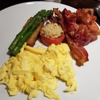 TOCA - Two Farm Fresh Eggs: bacon, garnished with  grilled tomato, asparagus, homemade  potato rösti ($22) - Italian Near Me - Toronto, Ontario