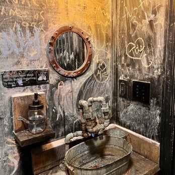 Wildwood Tavern - a sink and mirror in a bathroom - Bars Near Me - Florence, Alabama Wildwood Tavern - a sink and mirror in a bathroom - Bars Near Me - Florence, Alabama